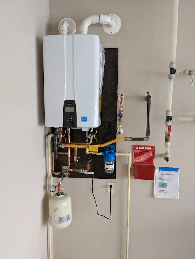 Professional plumber installing copper piping in a Cliffside Park home